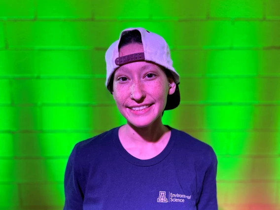 a photo of a person in a University of Arizona t-shirt in front of a brick background