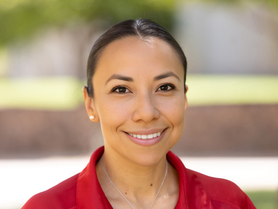 a photo of a person in a red polo shirt in front of a blurred outdoor scene